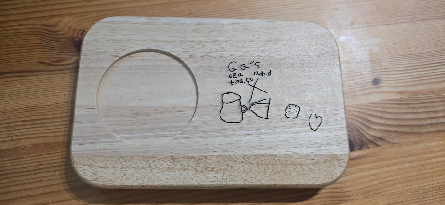Wooden tray with hand-drawn designs on a wooden surface