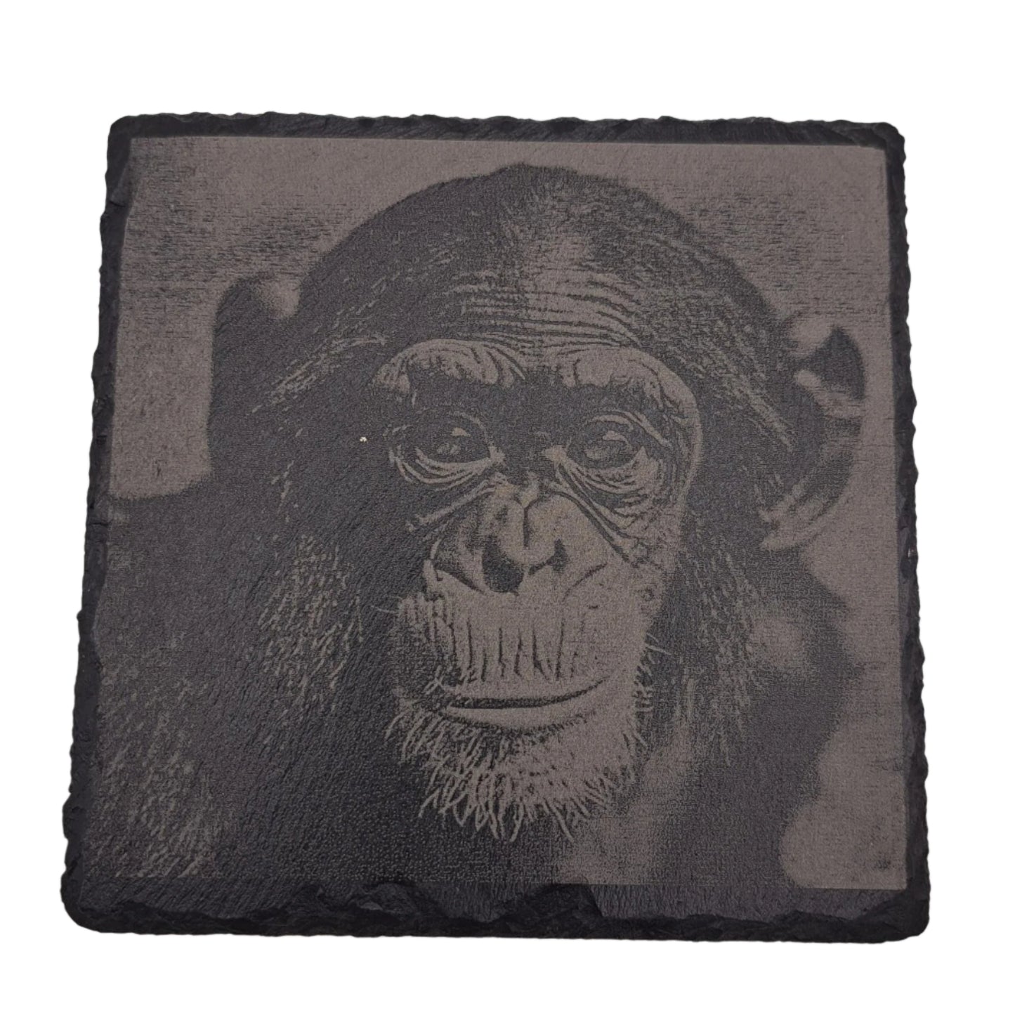 A beautifully etched slate coaster featuring a cute chimpanzee