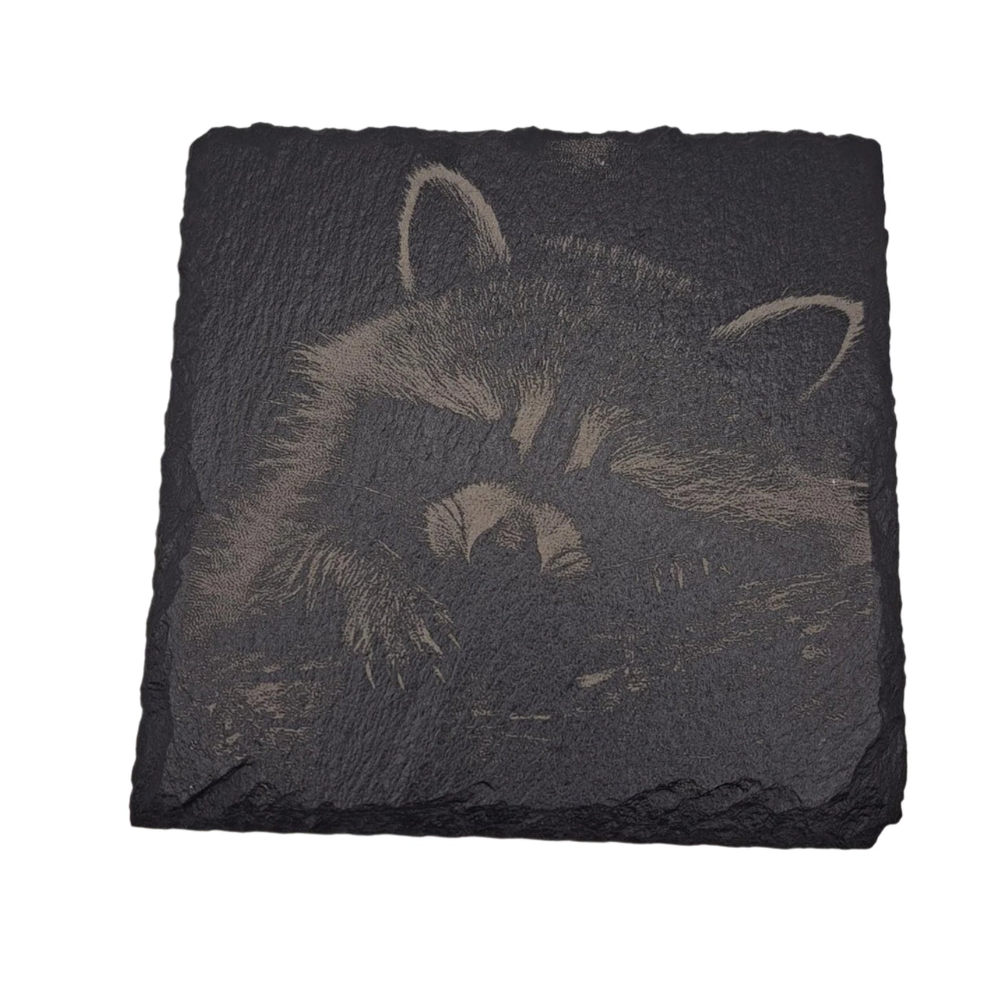 A beautifully etched slate coaster featuring a raccoon
