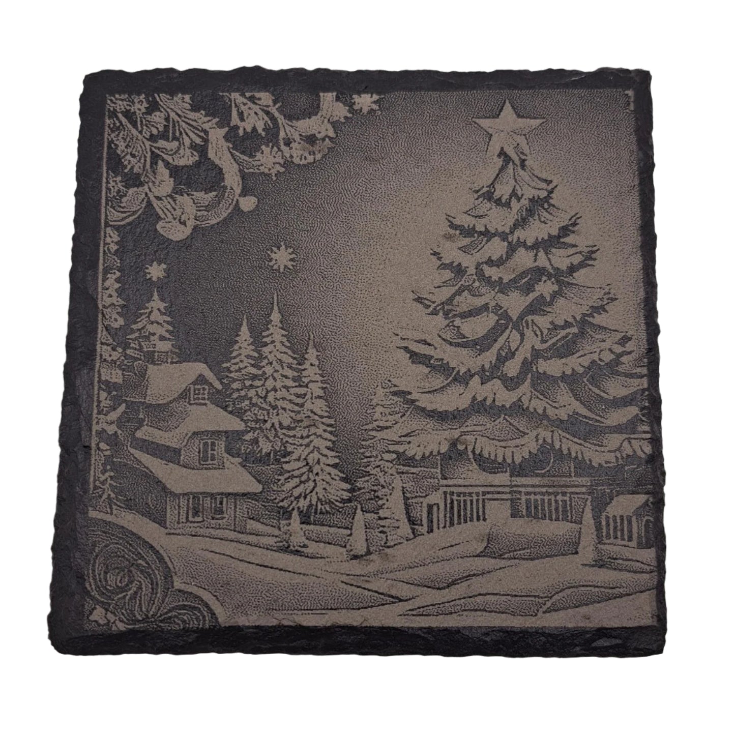 A beautifully etched slate coaster featuring a snowy Christmas scene