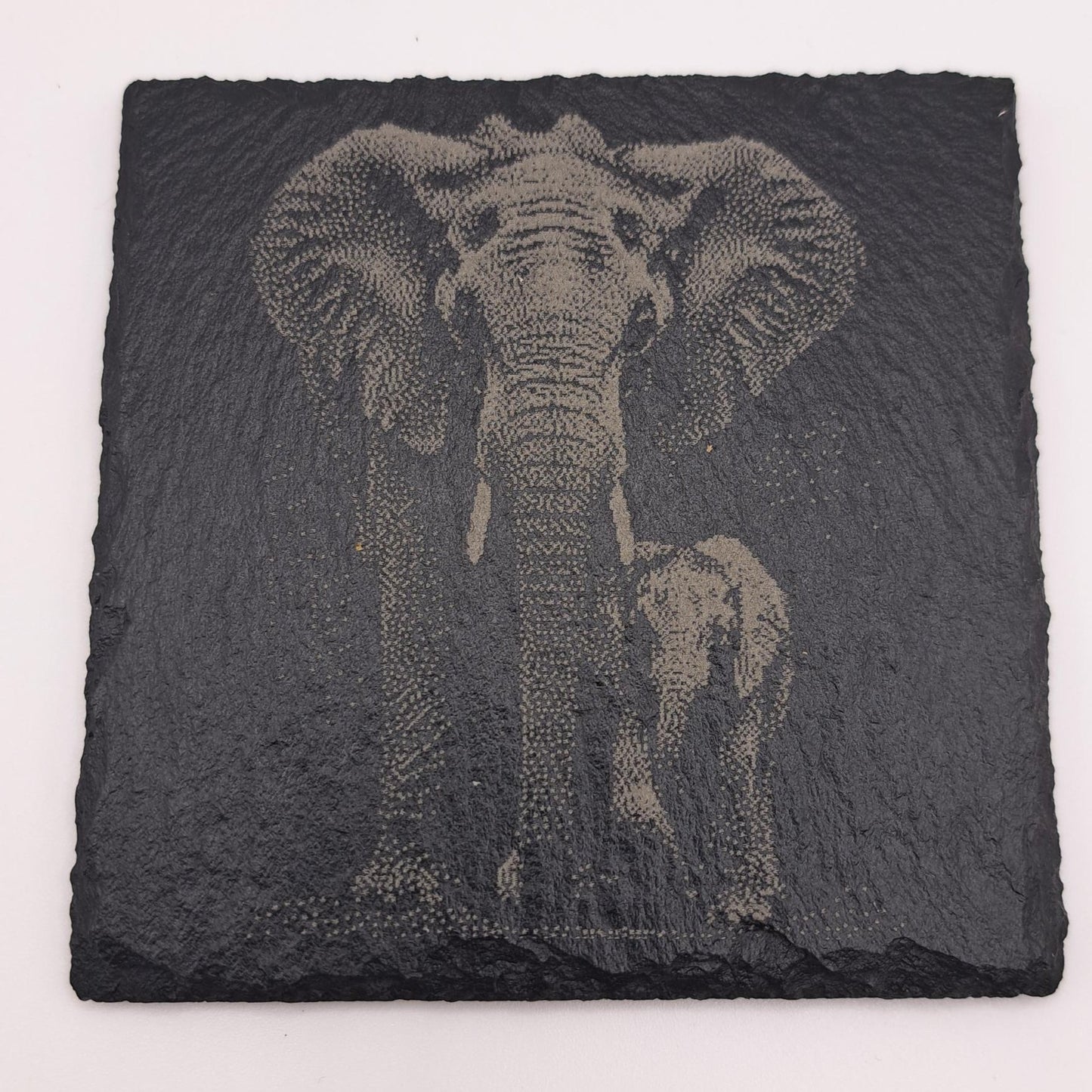 A beautifully etched slate coaster featuring an elephant and calf