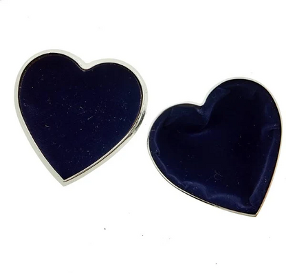Two heart-shaped objects with dark blue centers and silver edges on a white background